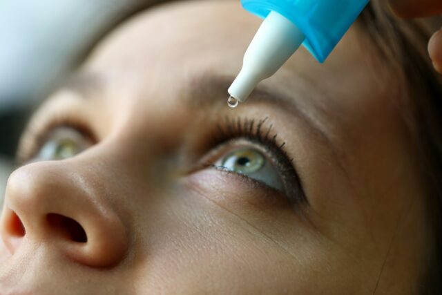 Woman having eye drops