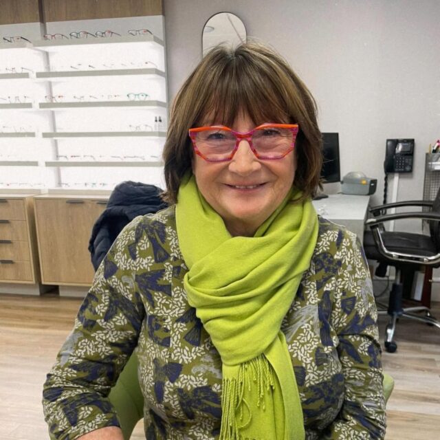 Older woman in red frames
